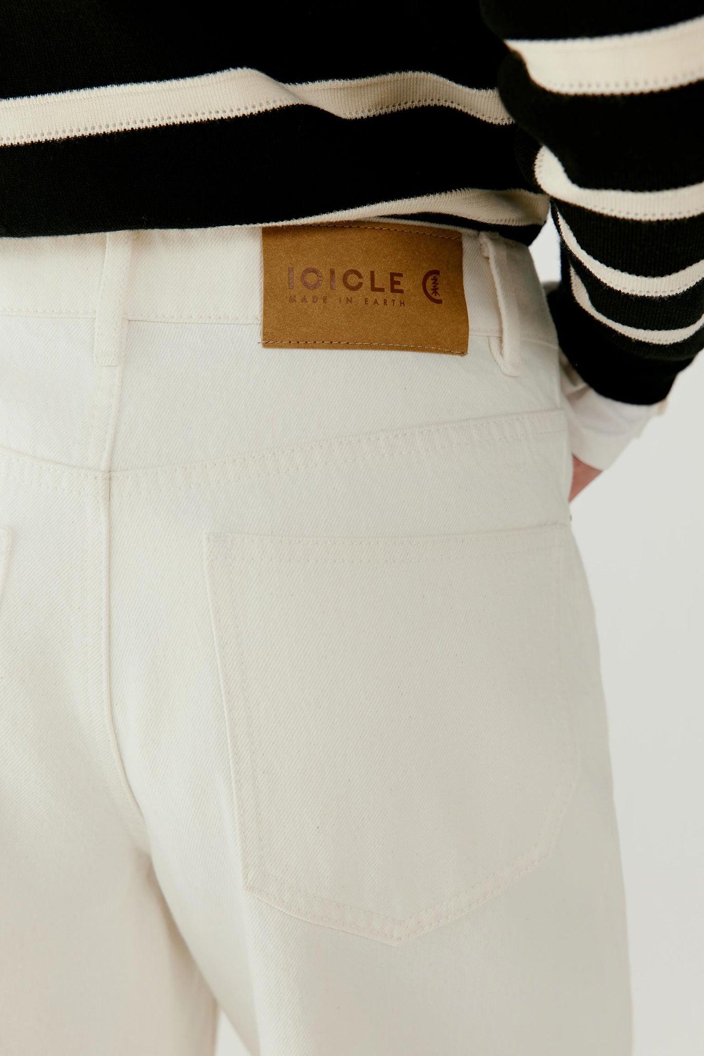 Close-up view highlighting the pocket opening and the natural texture of the undyed denim fabric.