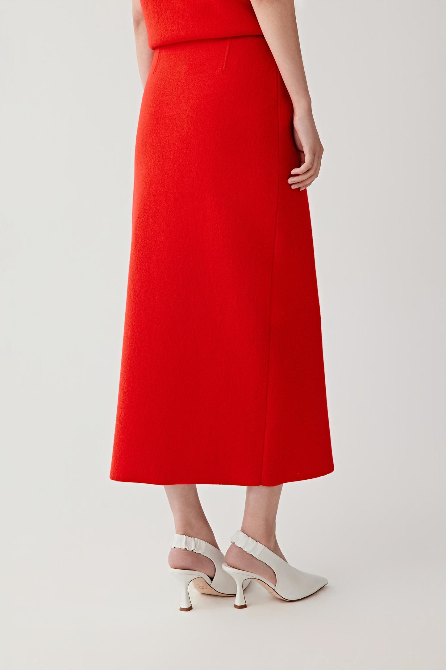 Three-quarter rear view focusing on the back of the heels, showing the slingback construction, heel shape and how the shoe sits securely while maintaining a clean, structured silhouette