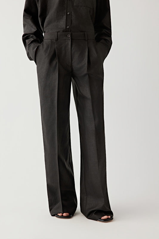 Front view of a model wearing straight-leg trousers crafted from silk using the traditional Gambiered Canton Gauze dyeing technique. The trousers feature a clean straight silhouette with a structured waistband and soft pleats that guide the fabric into fluid vertical lines.