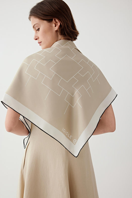 Back view highlighting the scarf spread across the upper back. The clean border frames the central motif while the silk twill structure gives the fabric gentle body.