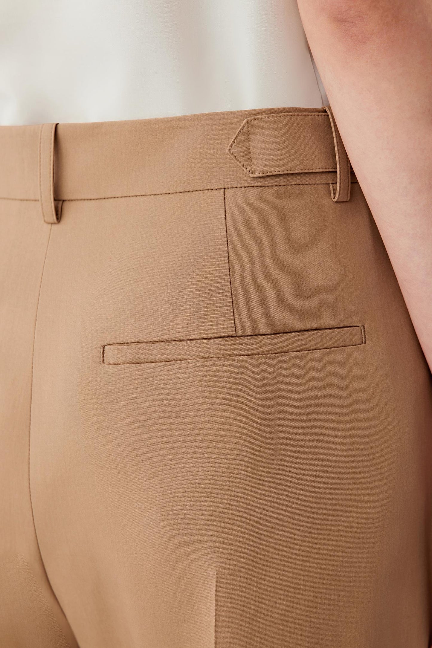 Close-up of pocket and fabric surface showing visible stitching, soft sheen and subtle tonal depth of the silk fabric