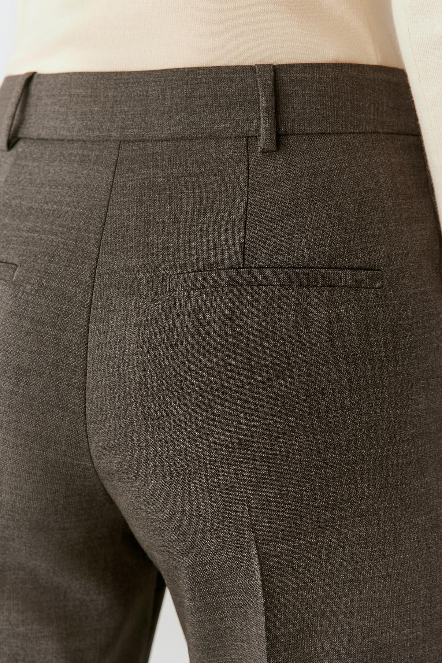 Close-up of the back waistband and welt pocket, highlighting the tailored construction and grey melange texture.