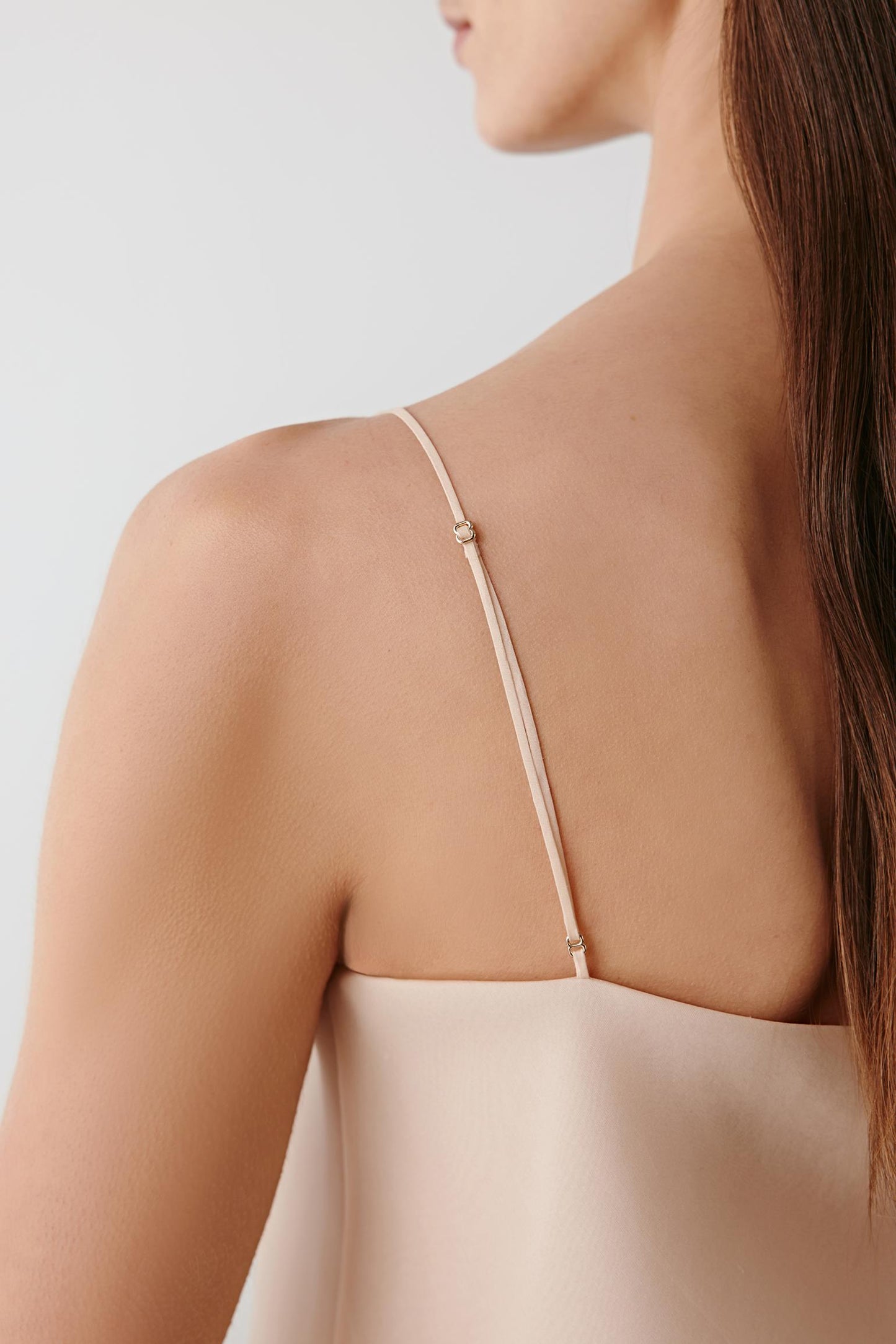 Rear detail view highlighting the open back and fine strap connection.