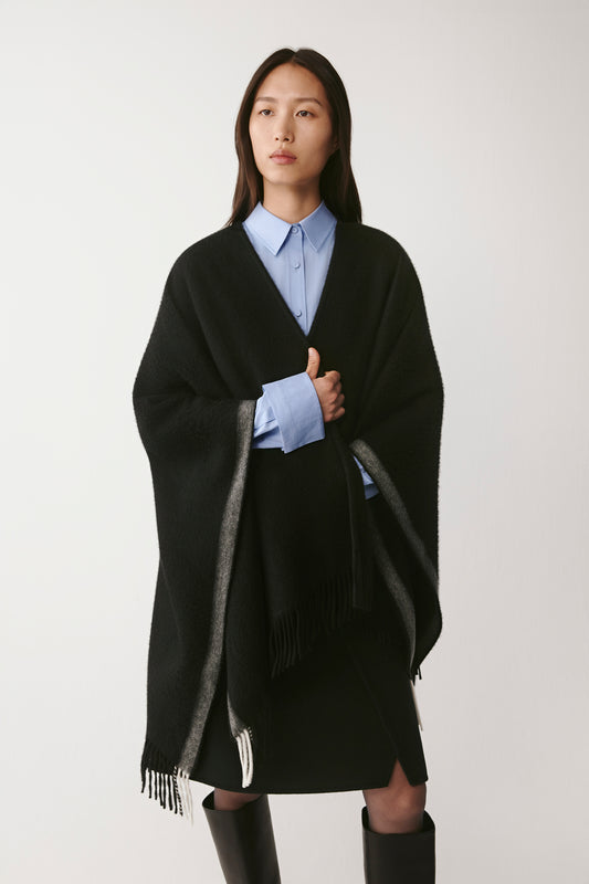 Front view showing the ample side of the shawl and its fluid movement around the shoulders.