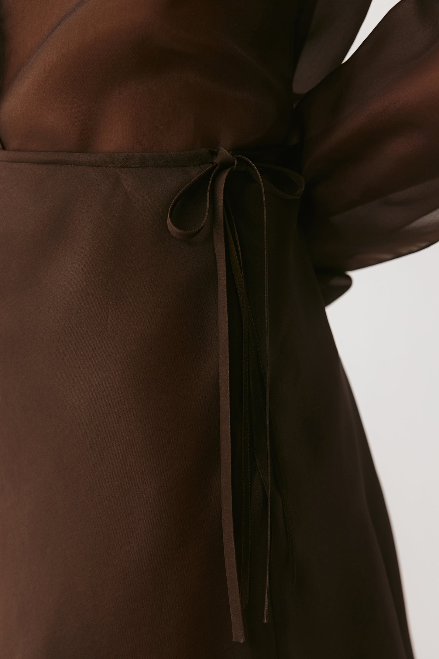 Close-up of the skirt’s texture, revealing the soft interplay of organza transparency and wool density.