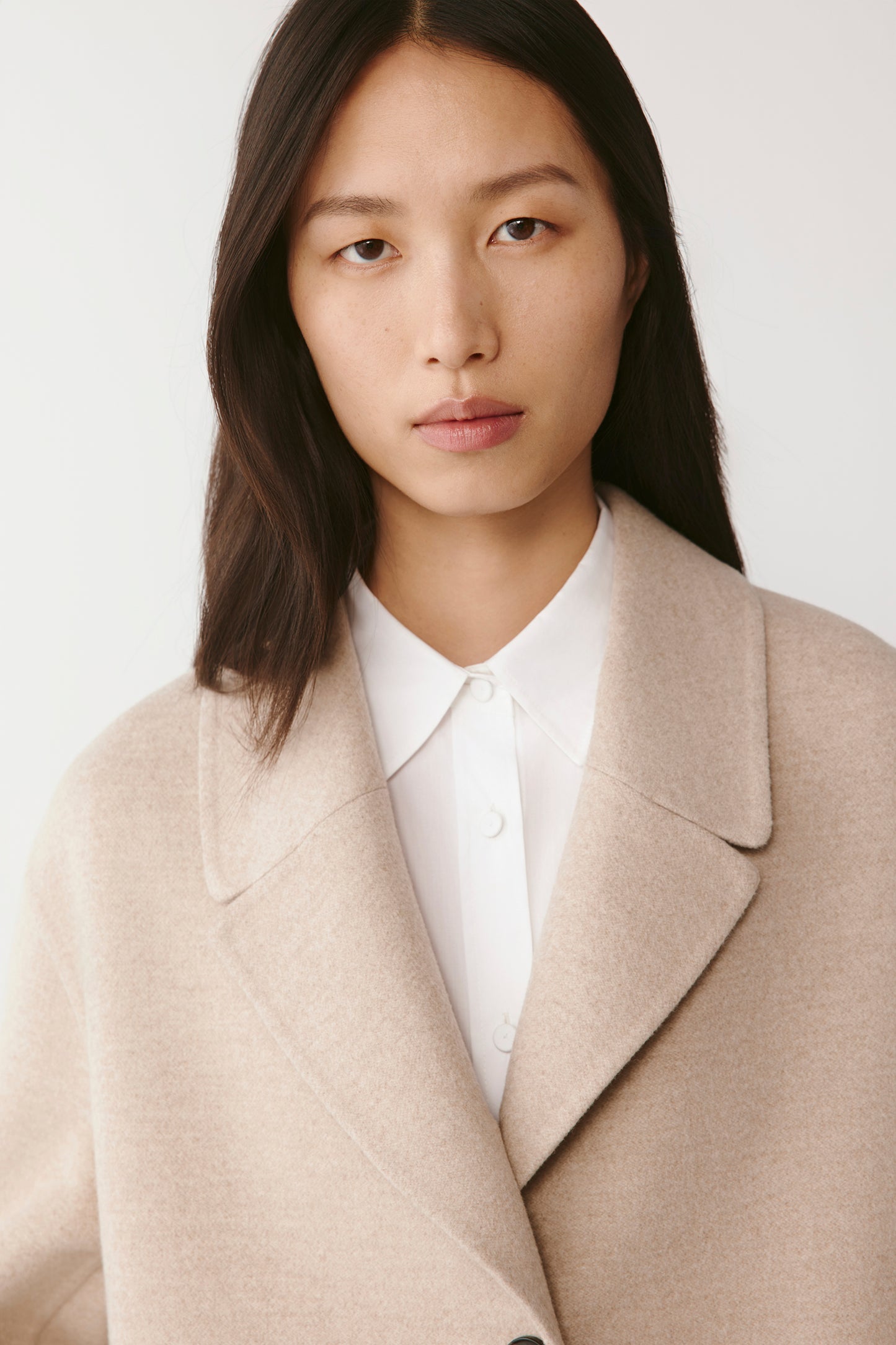 Portrait crop showing the soft collar lines and the natural tone of the cashmere.