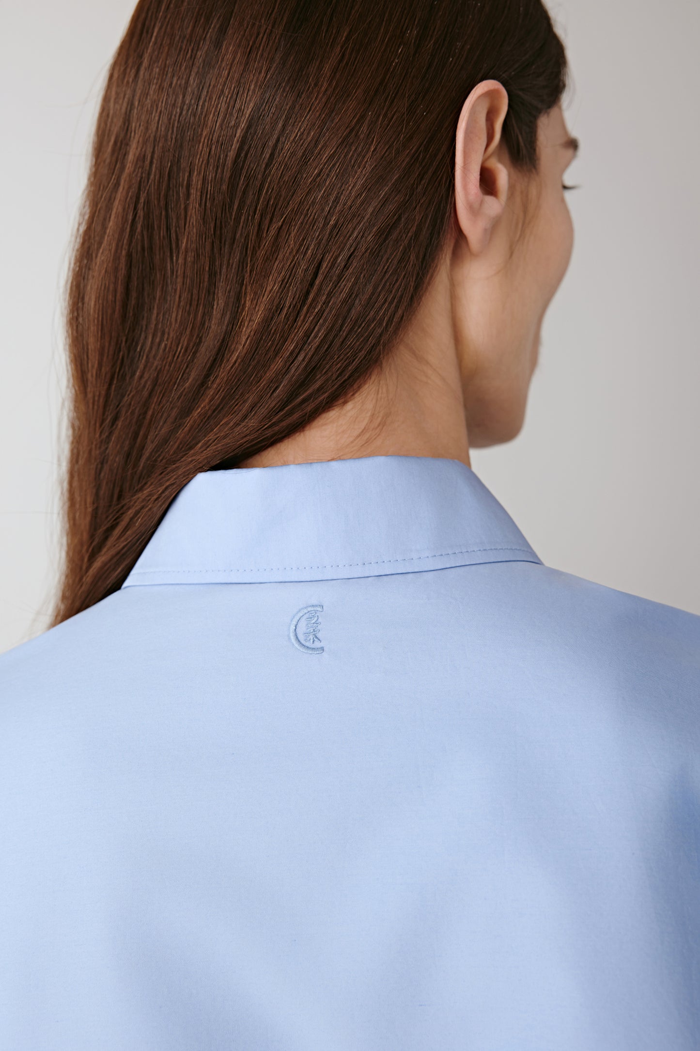 Detail of the back yoke and collar seam showing refined finishing.