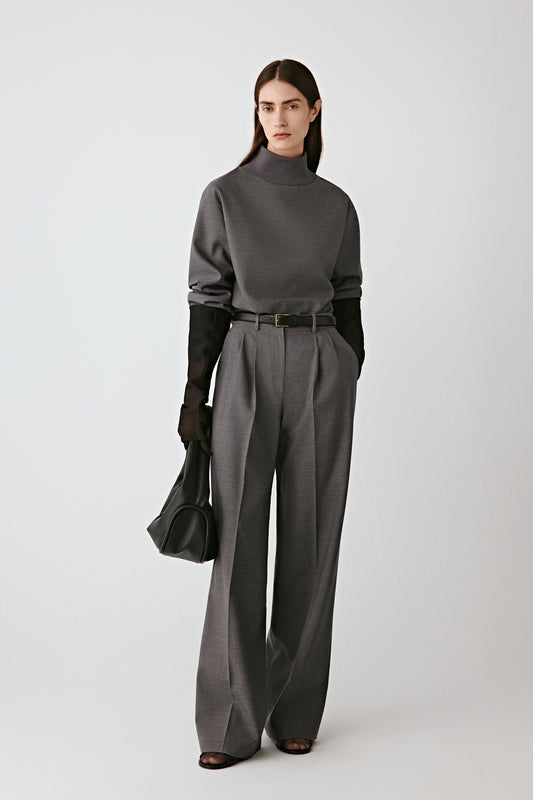 Three-quarter side view of the grey blouse, showing the smooth drape and fluid silhouette.