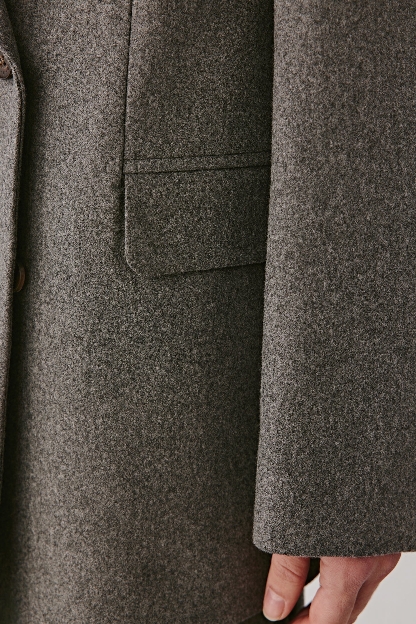 Detail of flap pockets and textured wool-silk fabric.