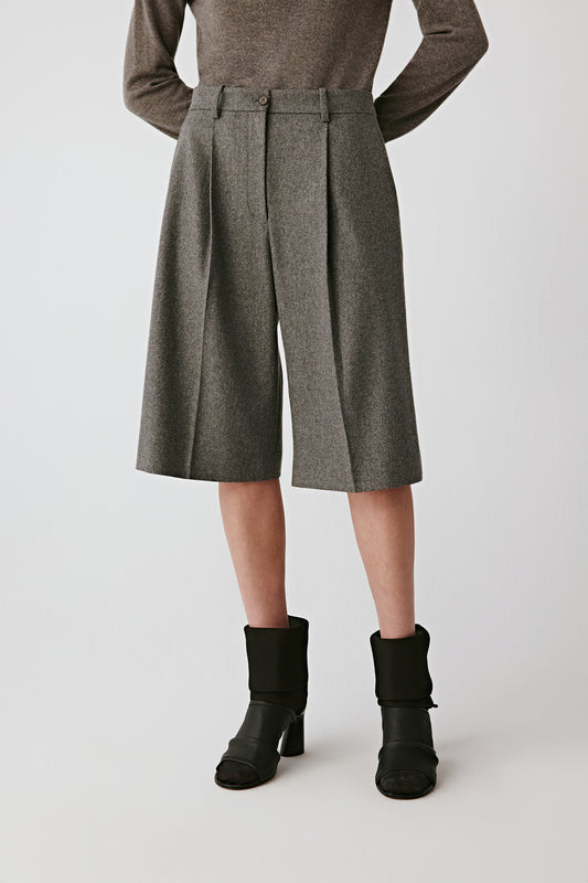 Three-quarter view highlighting the structured fit and front pleats.