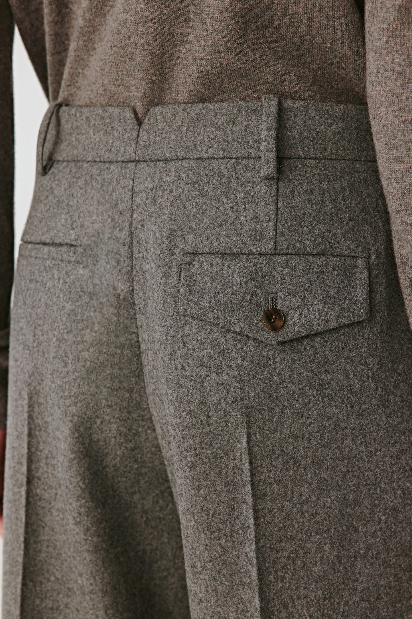 Close-up of the tweed texture and slanted pocket seam.