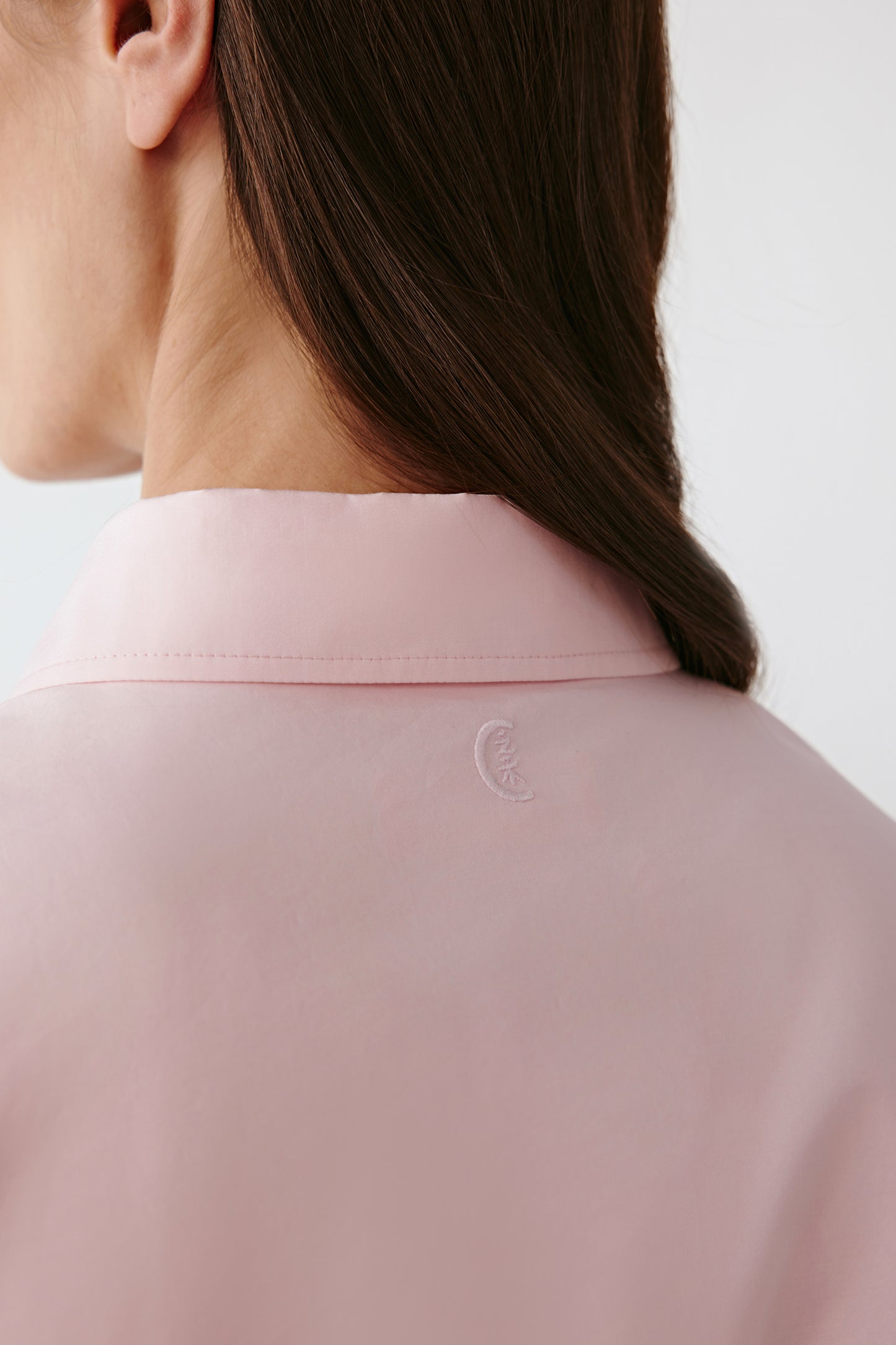 Back view revealing the smooth yoke and precise shoulder seams.