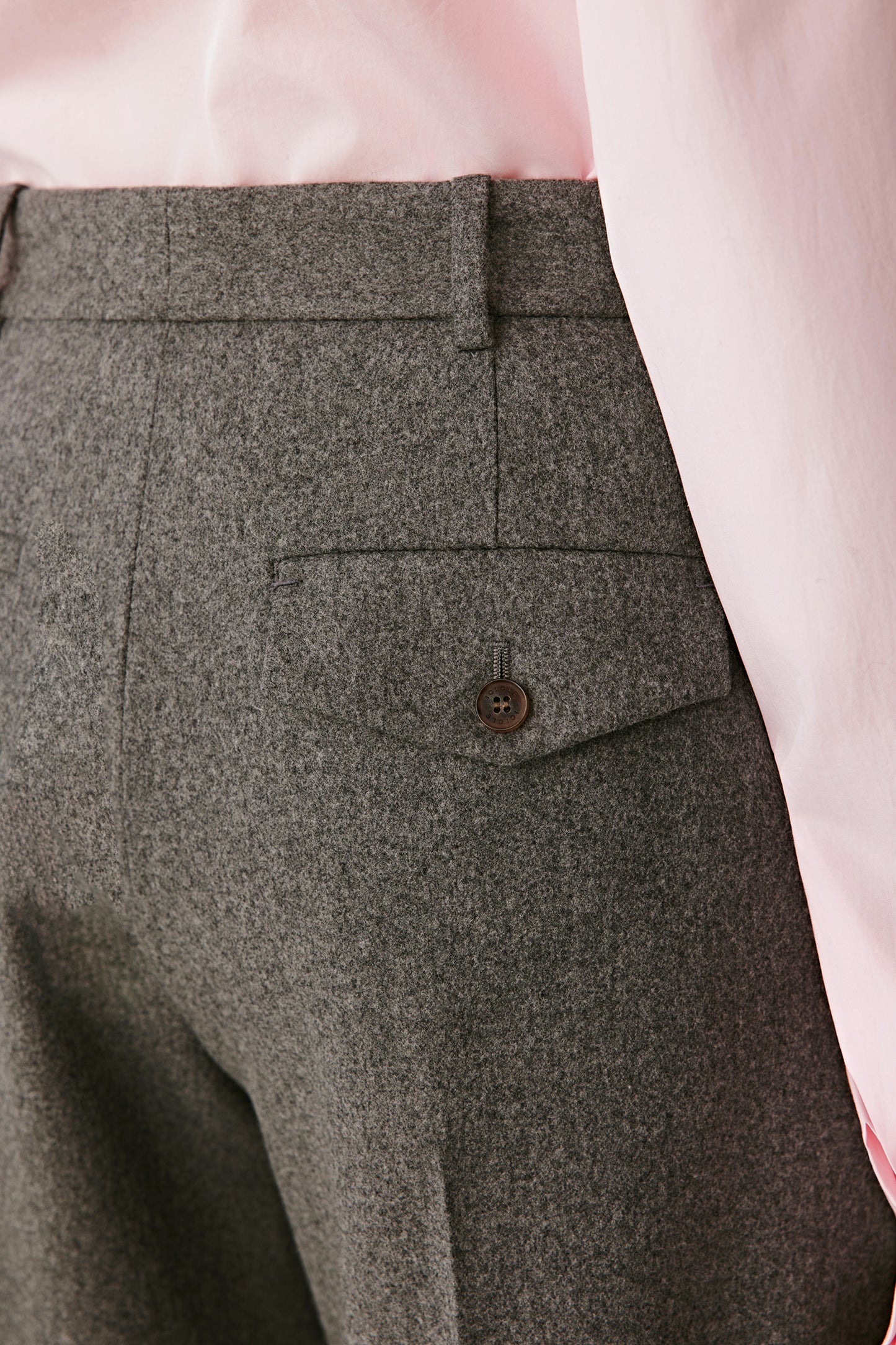 Back view of the trousers, highlighting the flowing lines and natural fabric movement.