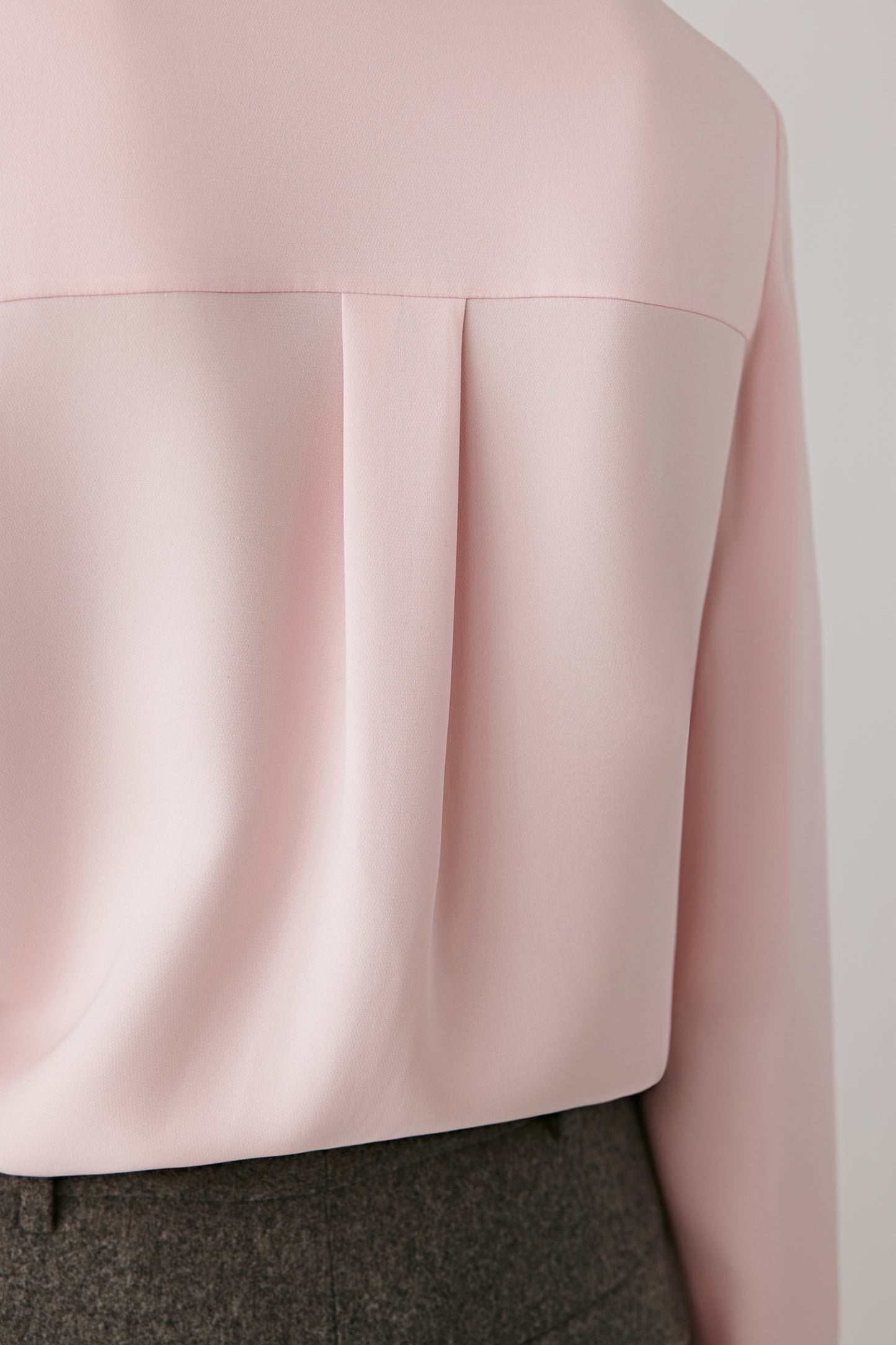 Close-up of the back focusing on the collar and shoulder seam, showing the smooth finish and fine craftsmanship of the garment.