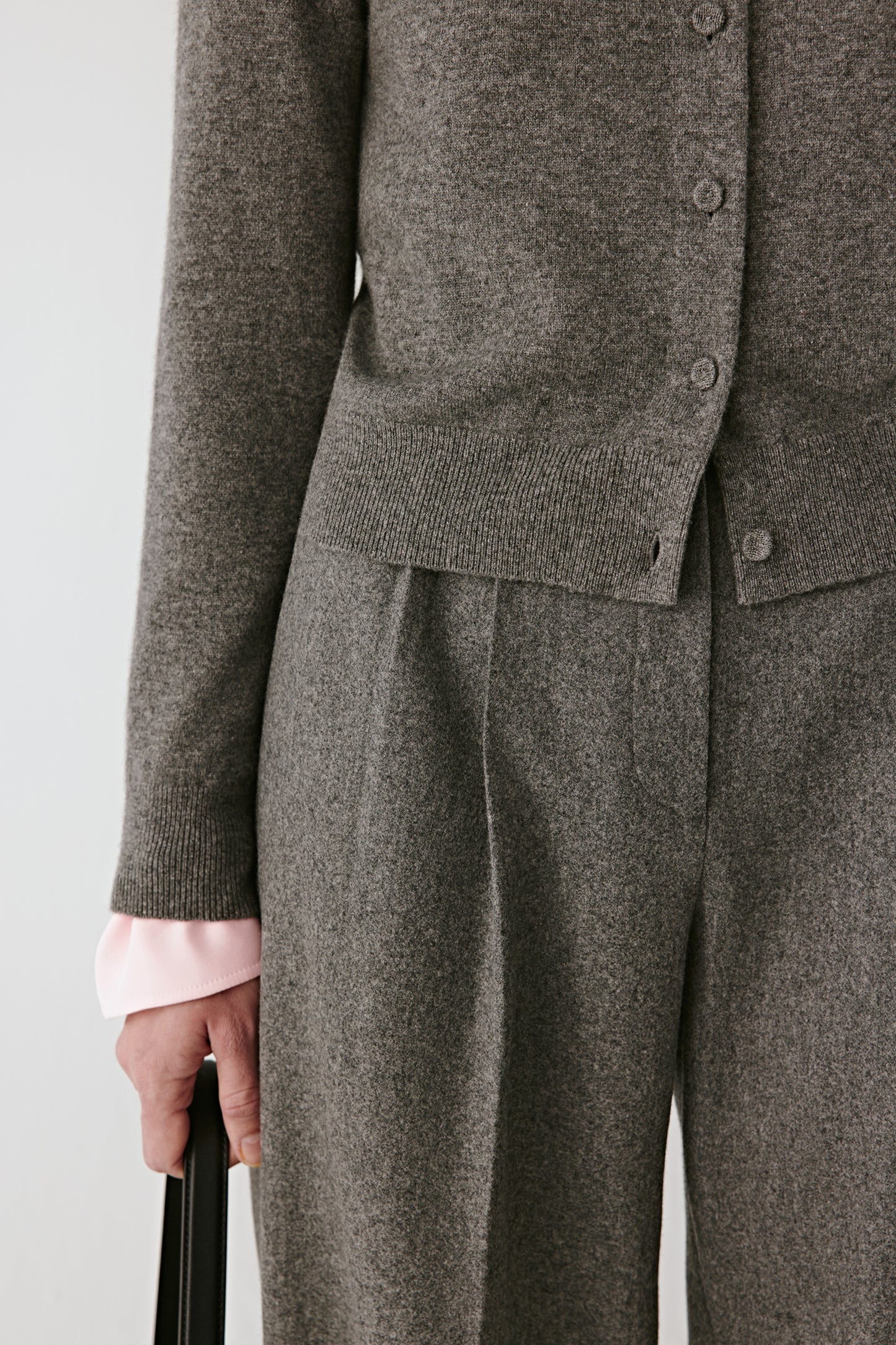 Detail close-up of the ribbed cuffs and tonal button placket.