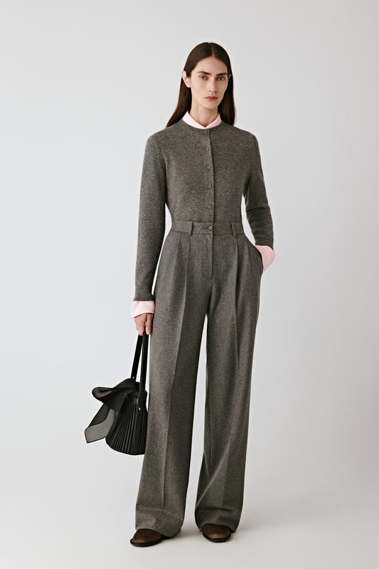 Full-length front view of the model wearing the grey cashmere cardigan with wide-leg trousers.