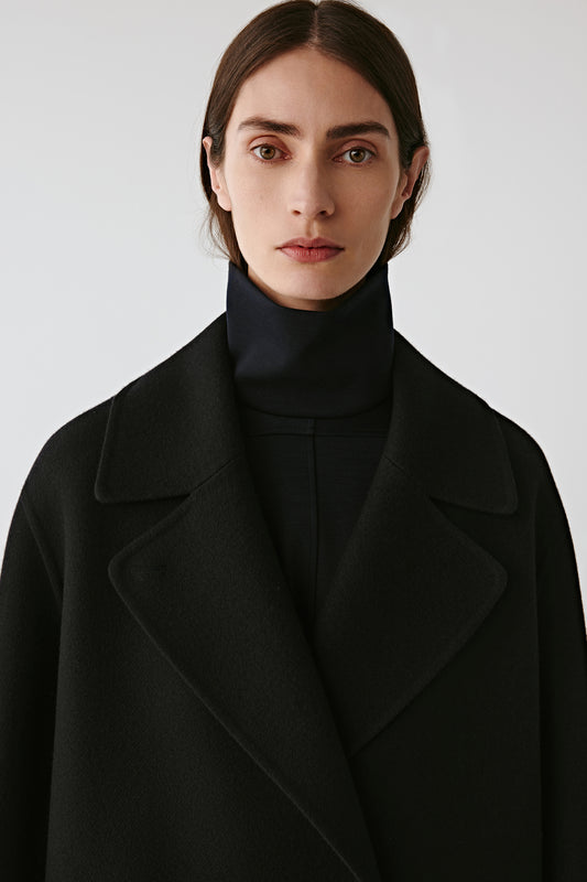 Close-up of the collar and neckline, highlighting the smooth wool texture and rich color tone.