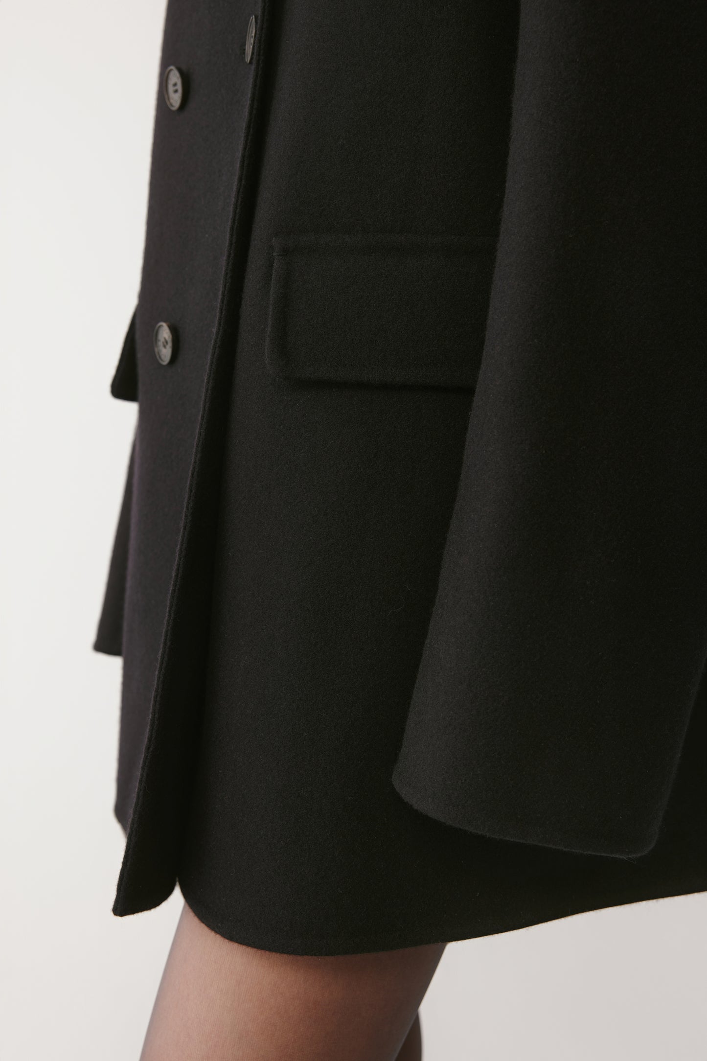 Detail shot of the pocket and collar, emphasizing the refined finishing and fabric quality.