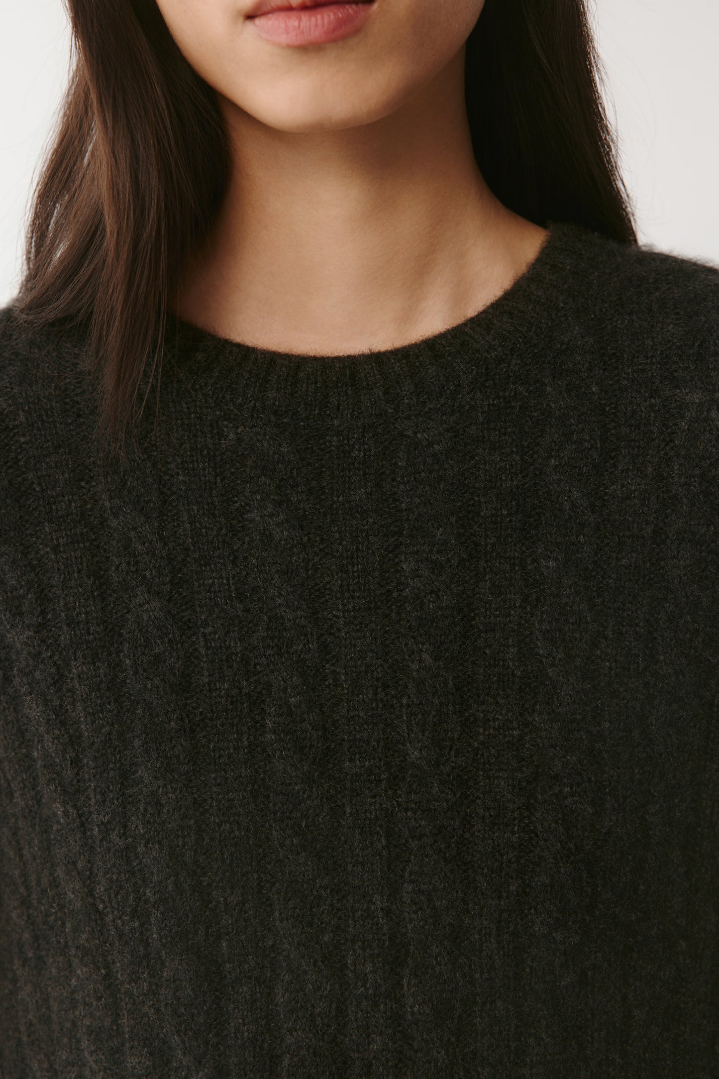 Detail shot of the buttons and knit pattern, emphasizing craftsmanship and luxurious texture.