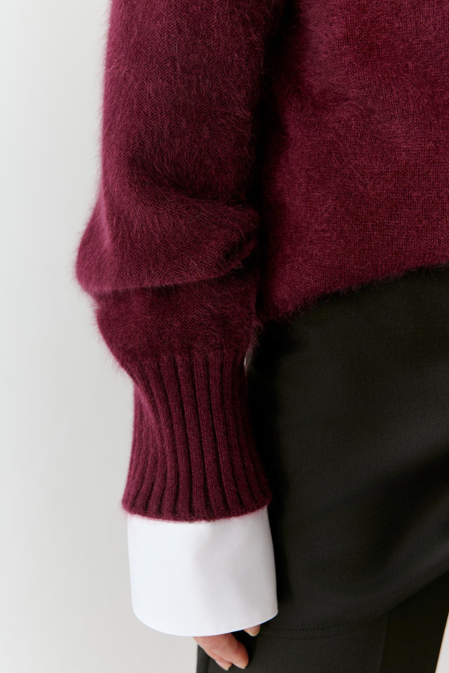 Close-up of the sleeve and cuff, highlighting the ribbed finish and soft cashmere texture.