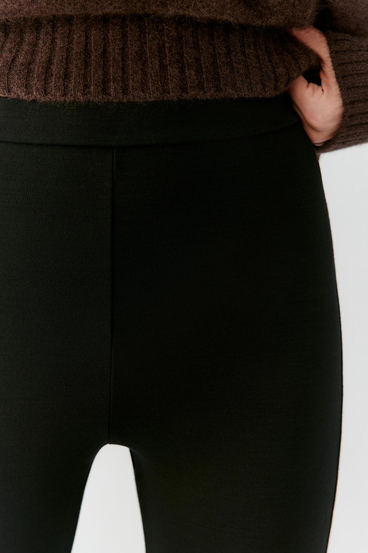 Close-up of the high-rise waistband and smooth grey melange wool jersey.