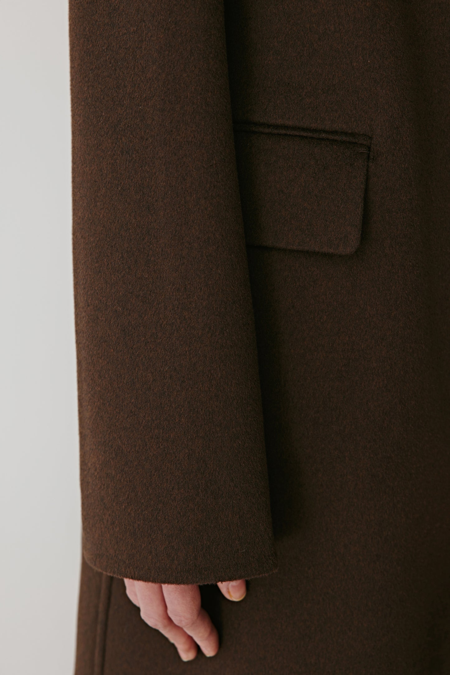 Close-up of the flap pocket, showing the smooth wool-silk texture.