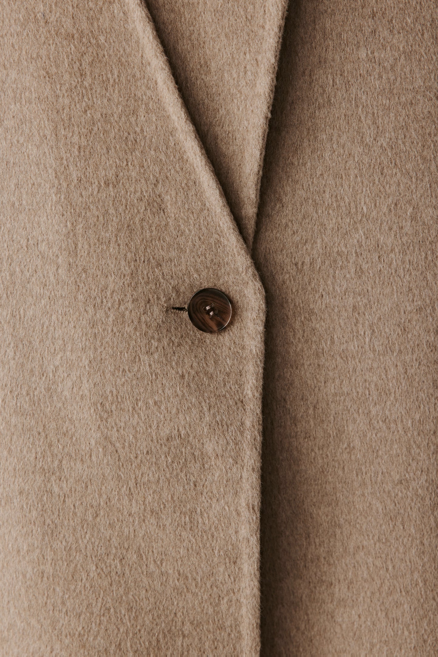 Close-up of the lapel and pocket detailing showing the dense, luxurious cashmere weave.