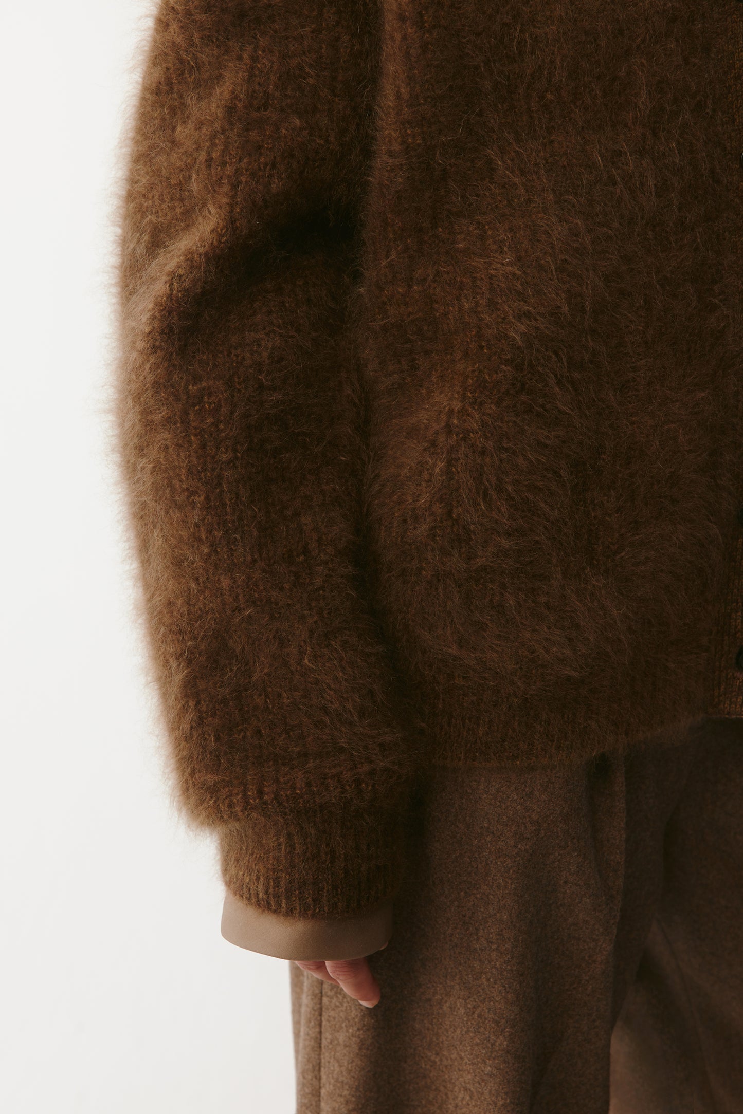 Detail shot of the sleeve and hem, emphasizing the plush cashmere knit.