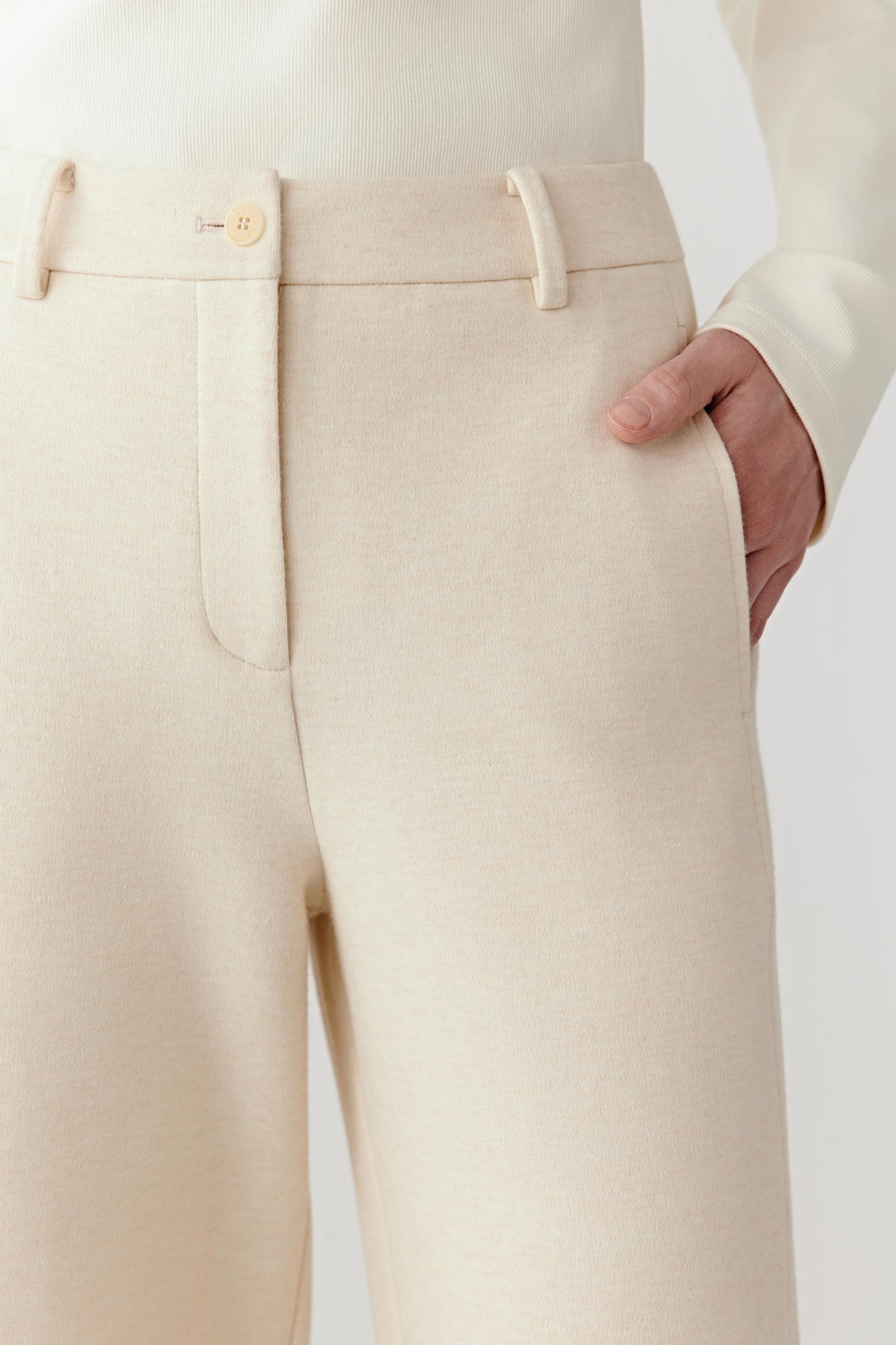 Close-up of belt loops and topstitching showing subtle craftsmanship.