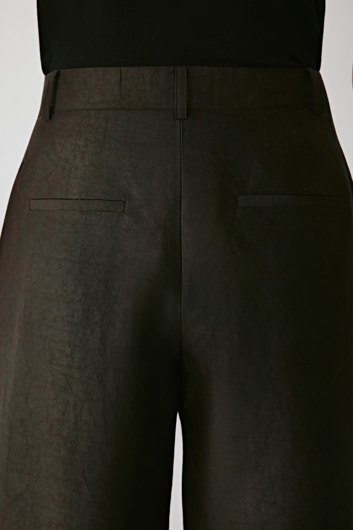 Another detail view reveals the fabric’s subtle texture and refined craftsmanship under soft lighting.