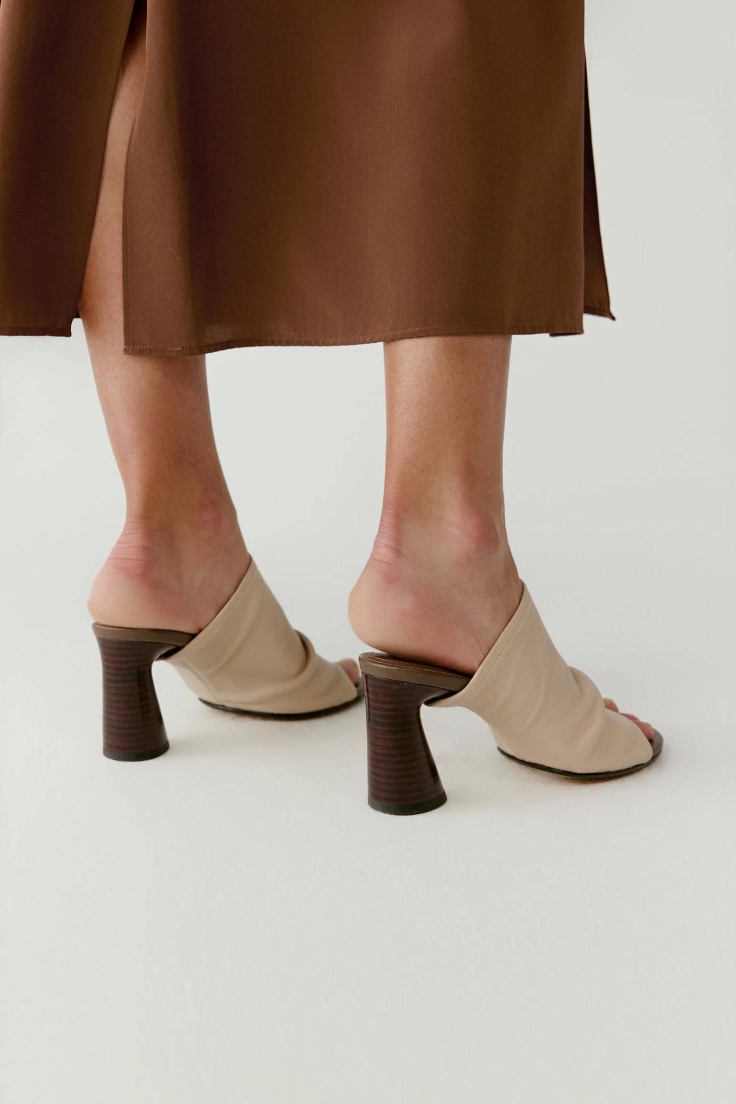 Back view showing the heel structure and the smooth leather finish along the back of the sandal.