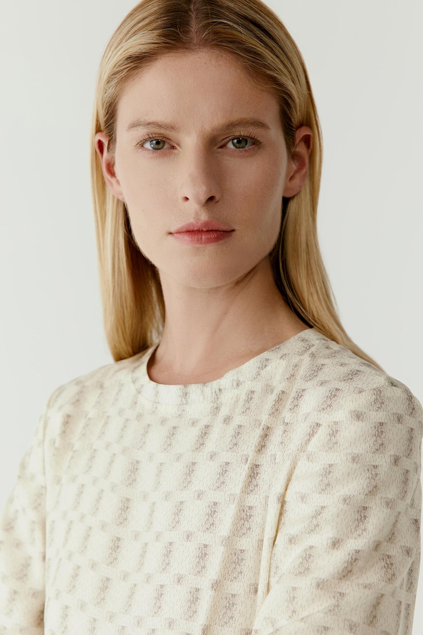 Close-up portrait highlighting the neckline, delicate print and soft, lightweight texture of the fabric