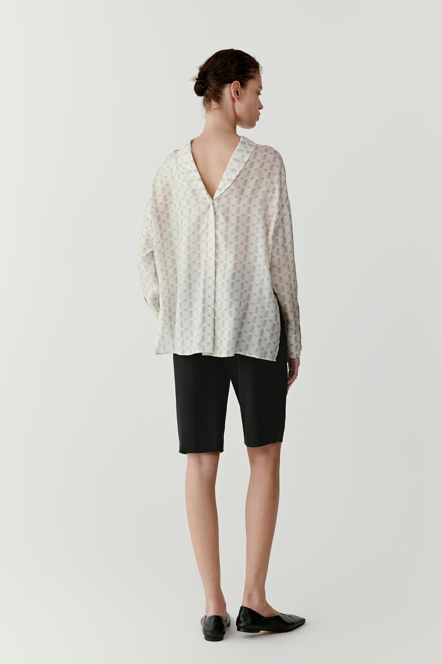 Full-length back view emphasizing the clean lines, relaxed fit through the body and natural movement of the fabric