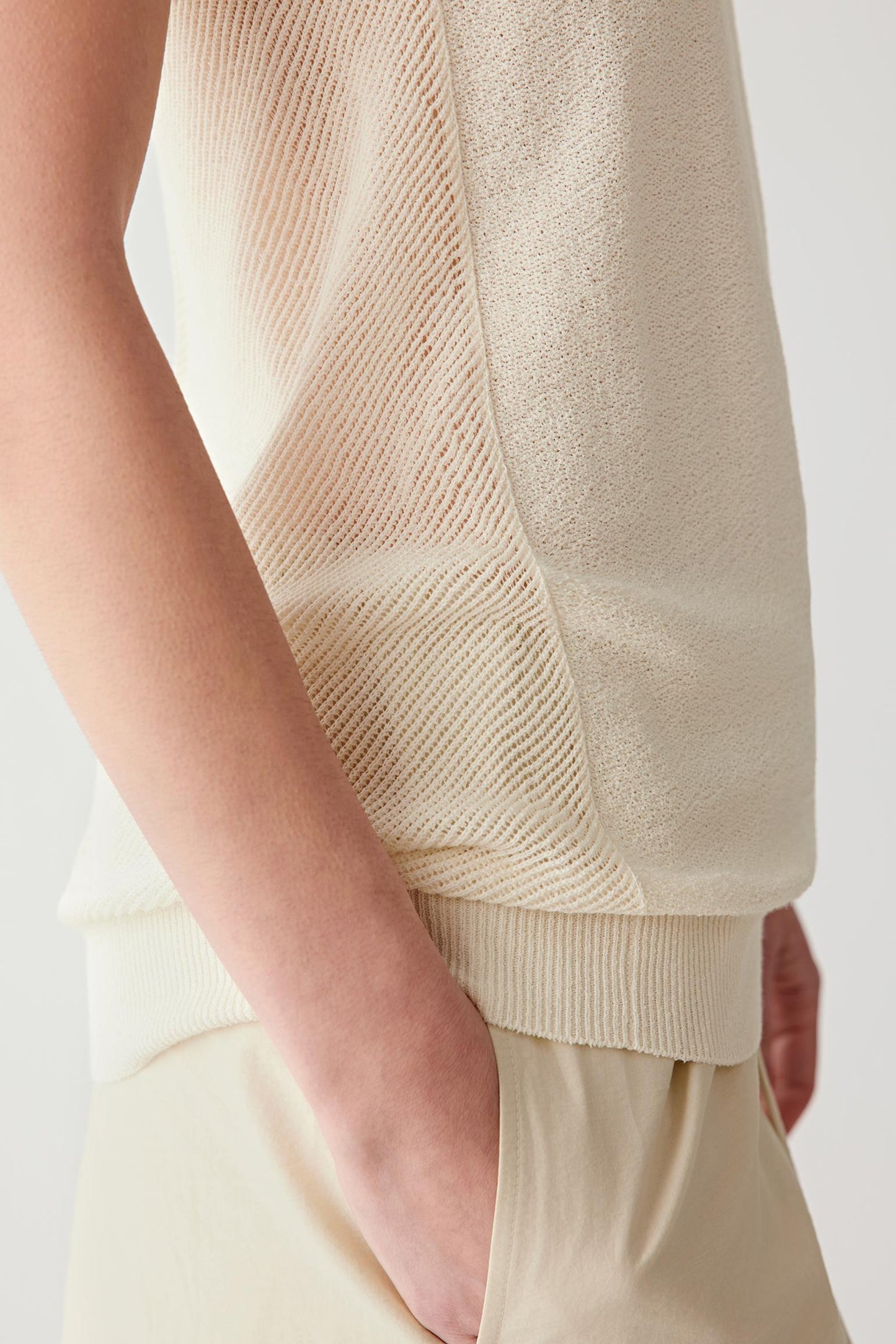 Close-up of side seam and ribbed trim showing the lightweight knit construction, ribbed finishing and subtle tonal variation of the silk and nylon blend