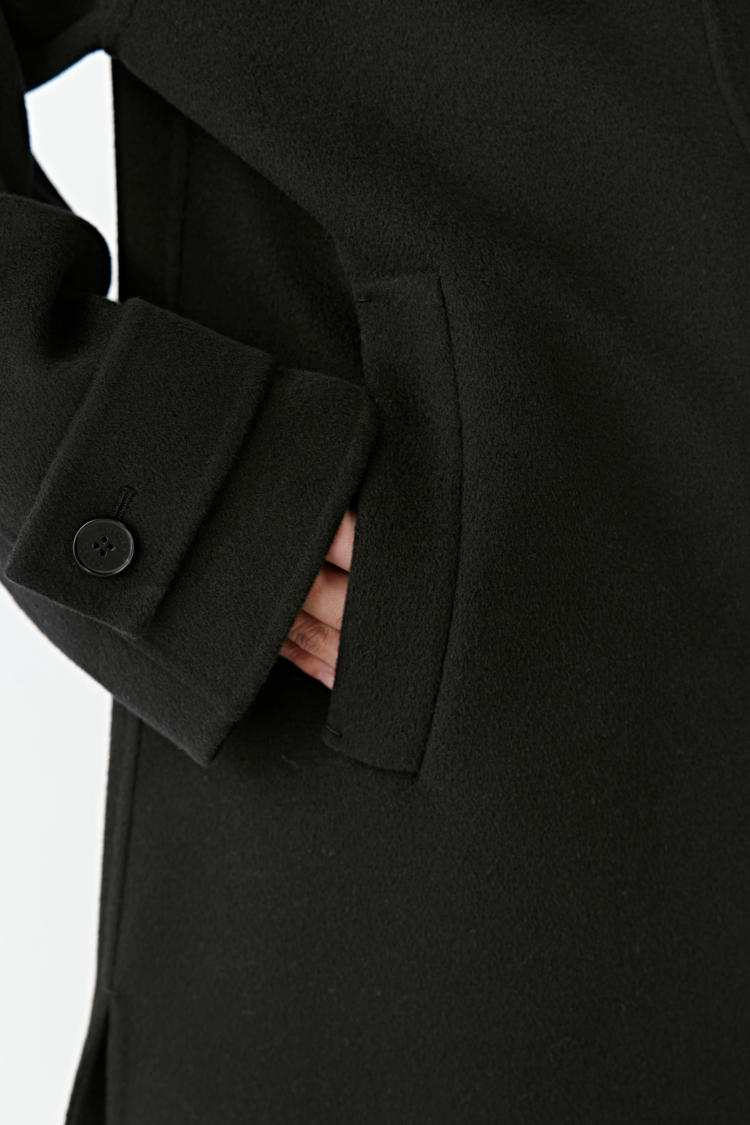 Detail of the sleeve and button showing the fine tailoring.