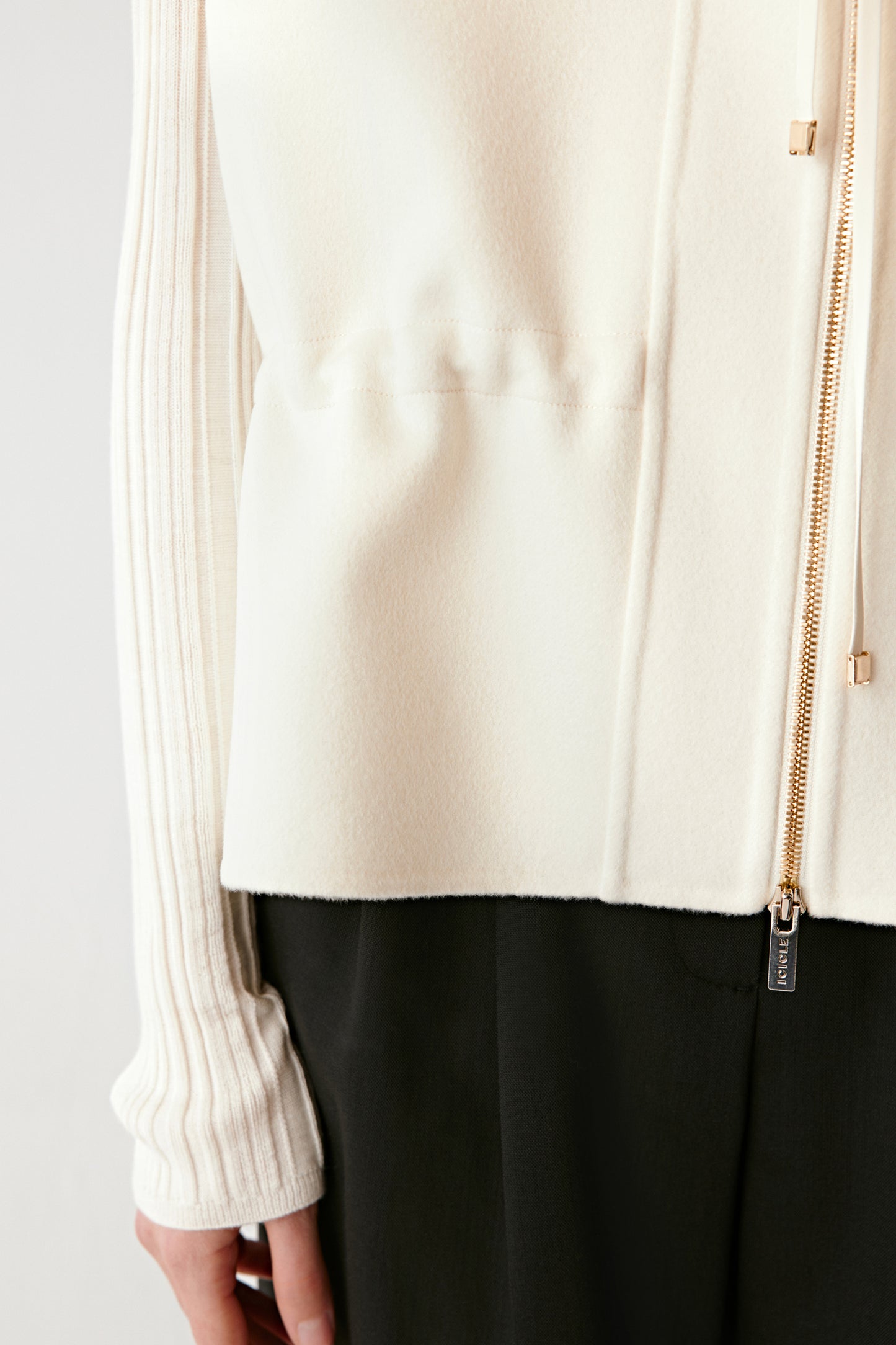 Close-up portrait showing the refined finish and subtle cream tone.