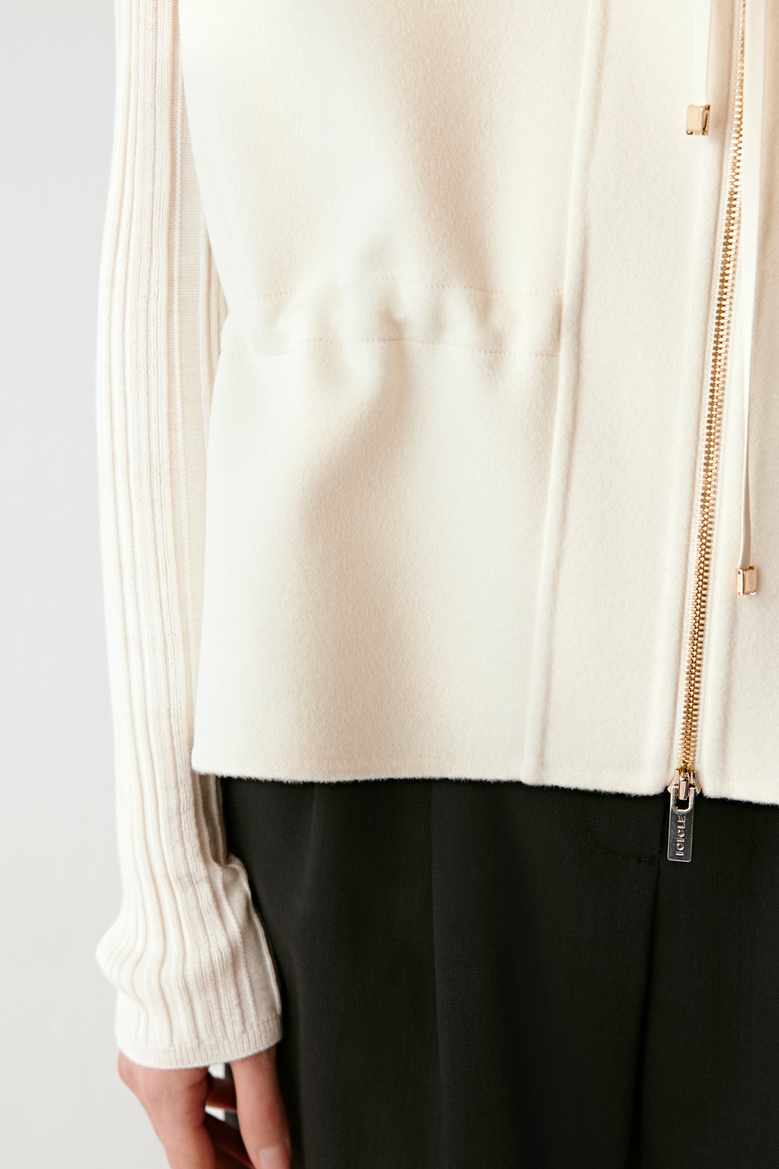 Close-up portrait showing the refined finish and subtle cream tone.