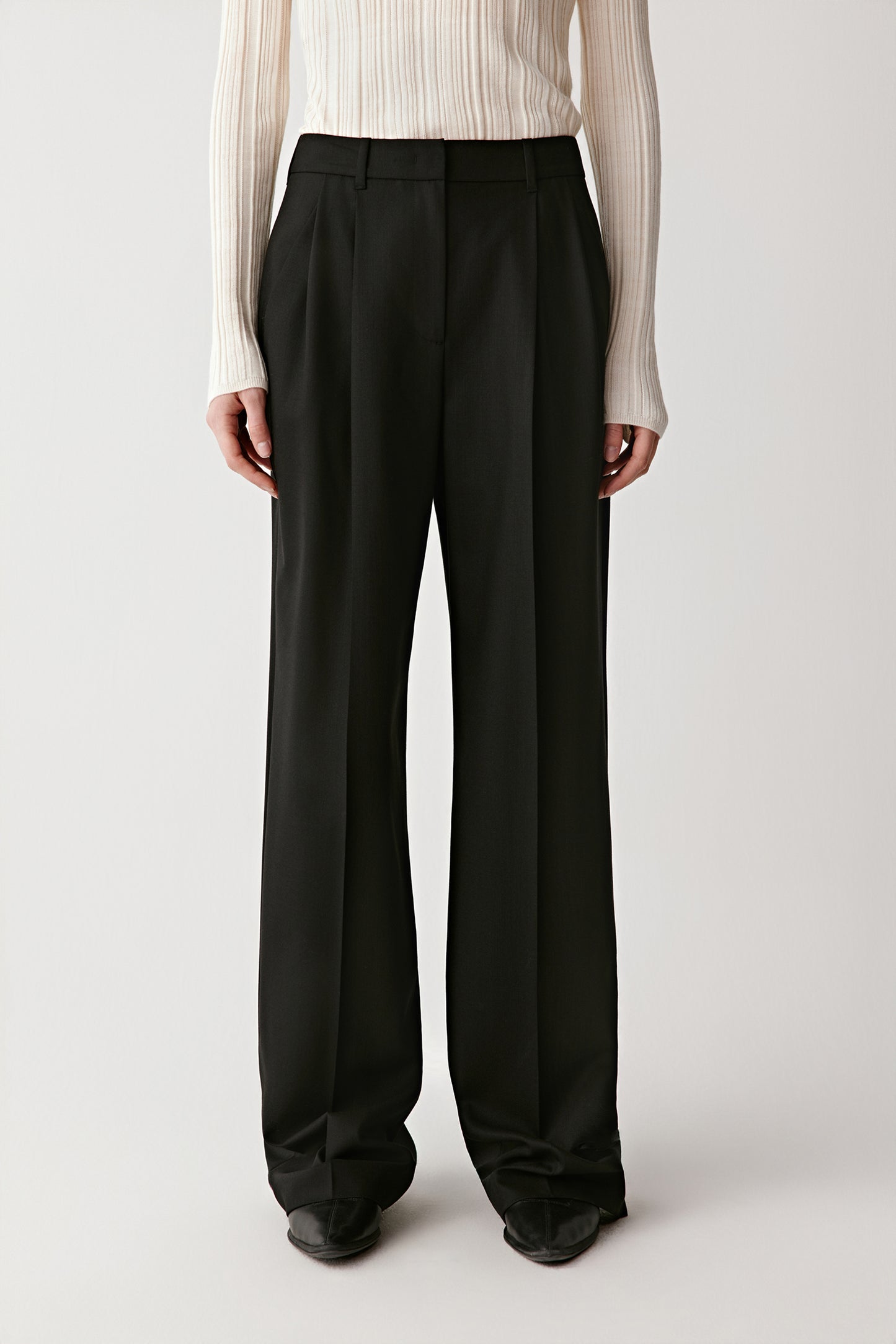 Front view showing the fluid drape and tailored waistline.