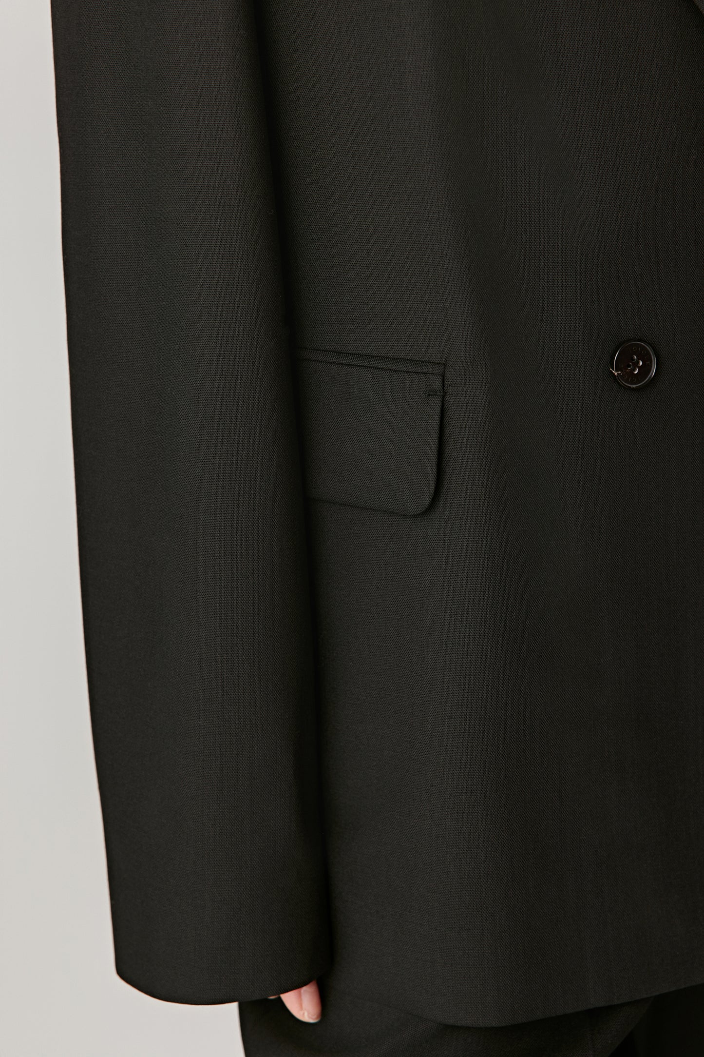 Three-quarter view showing the jacket sleeve, pocket and button for an elegant touch.