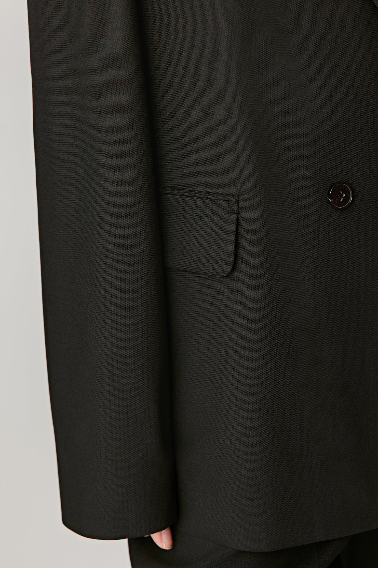 Three-quarter view showing the jacket sleeve, pocket and button for an elegant touch.