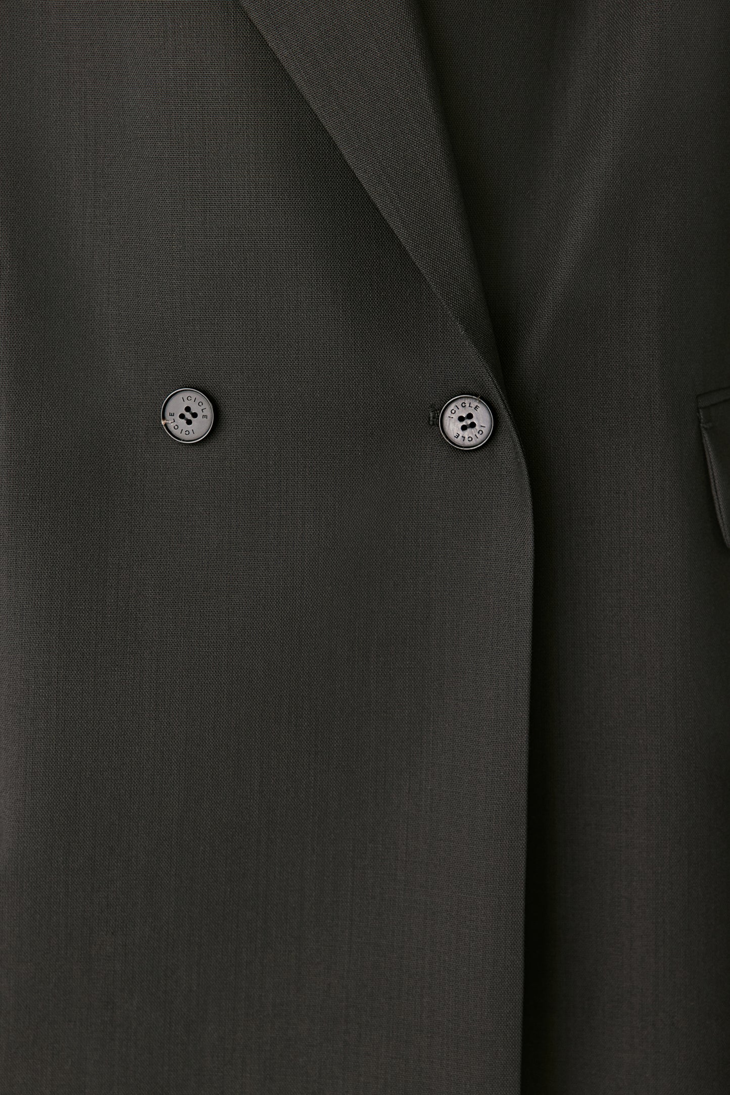 Close-up detail of the double-breasted buttons and fine weave.