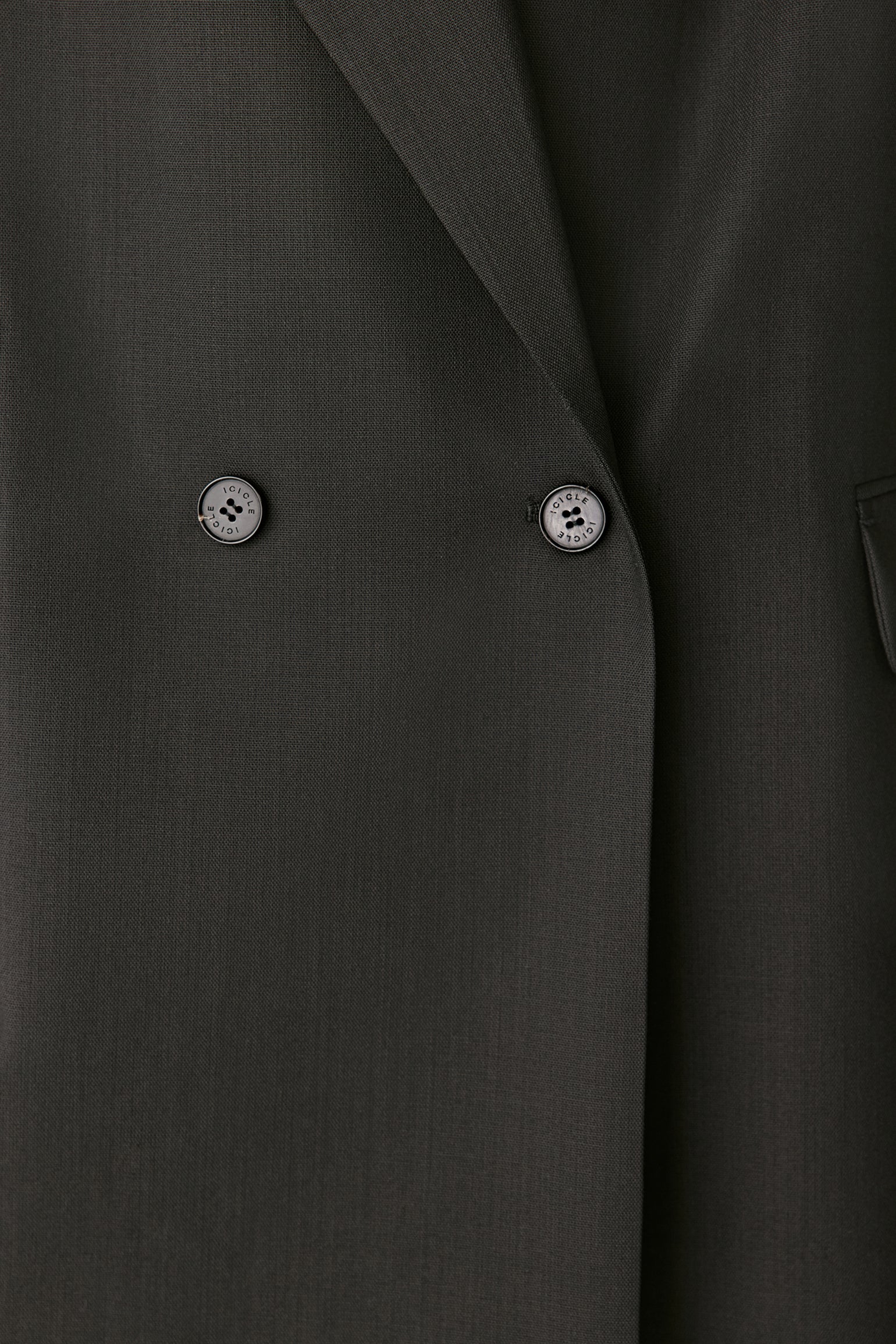 Close-up detail of the double-breasted buttons and fine weave.