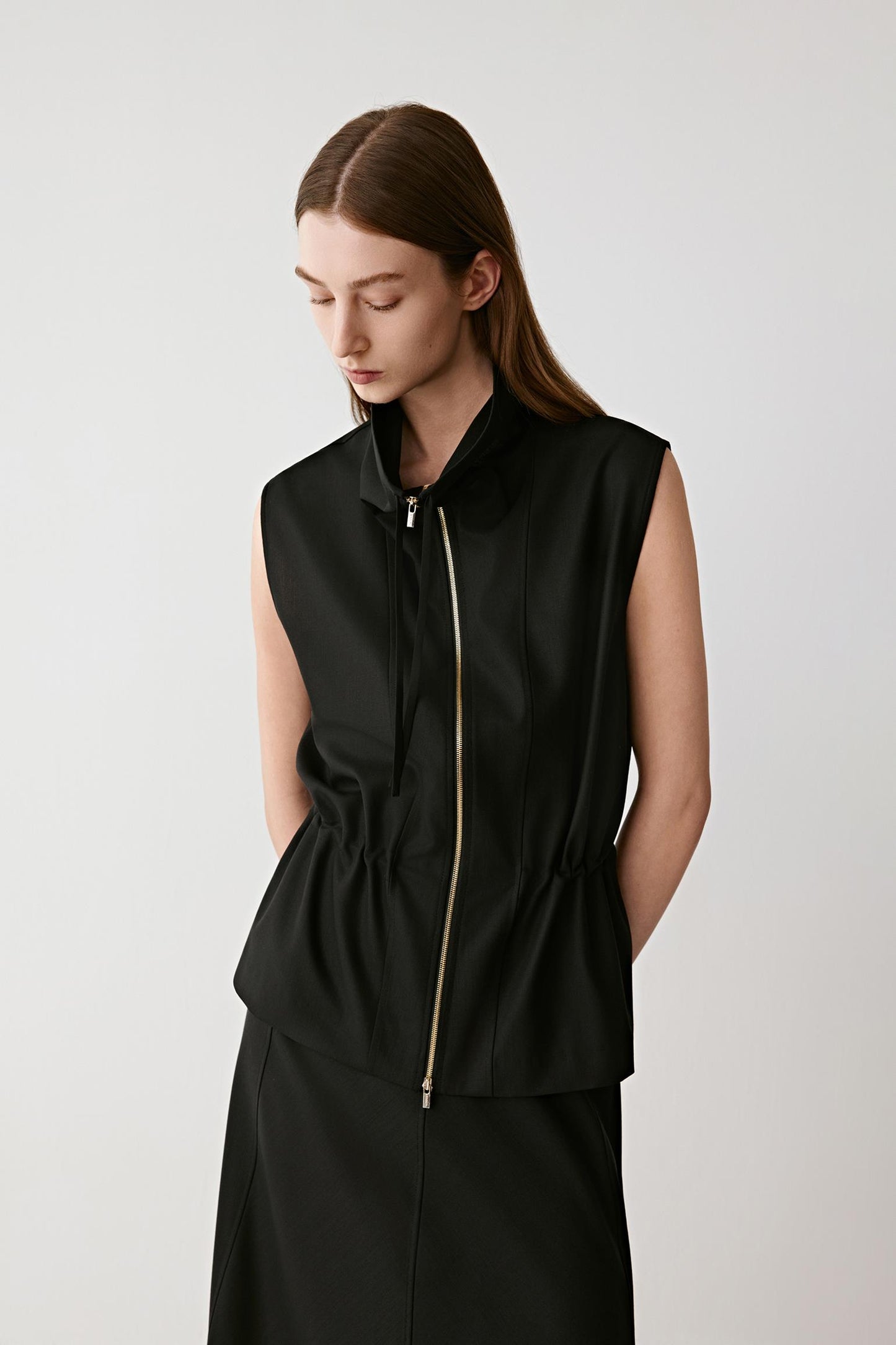 Three-quarter view showing the vertical seams and zip-front design.