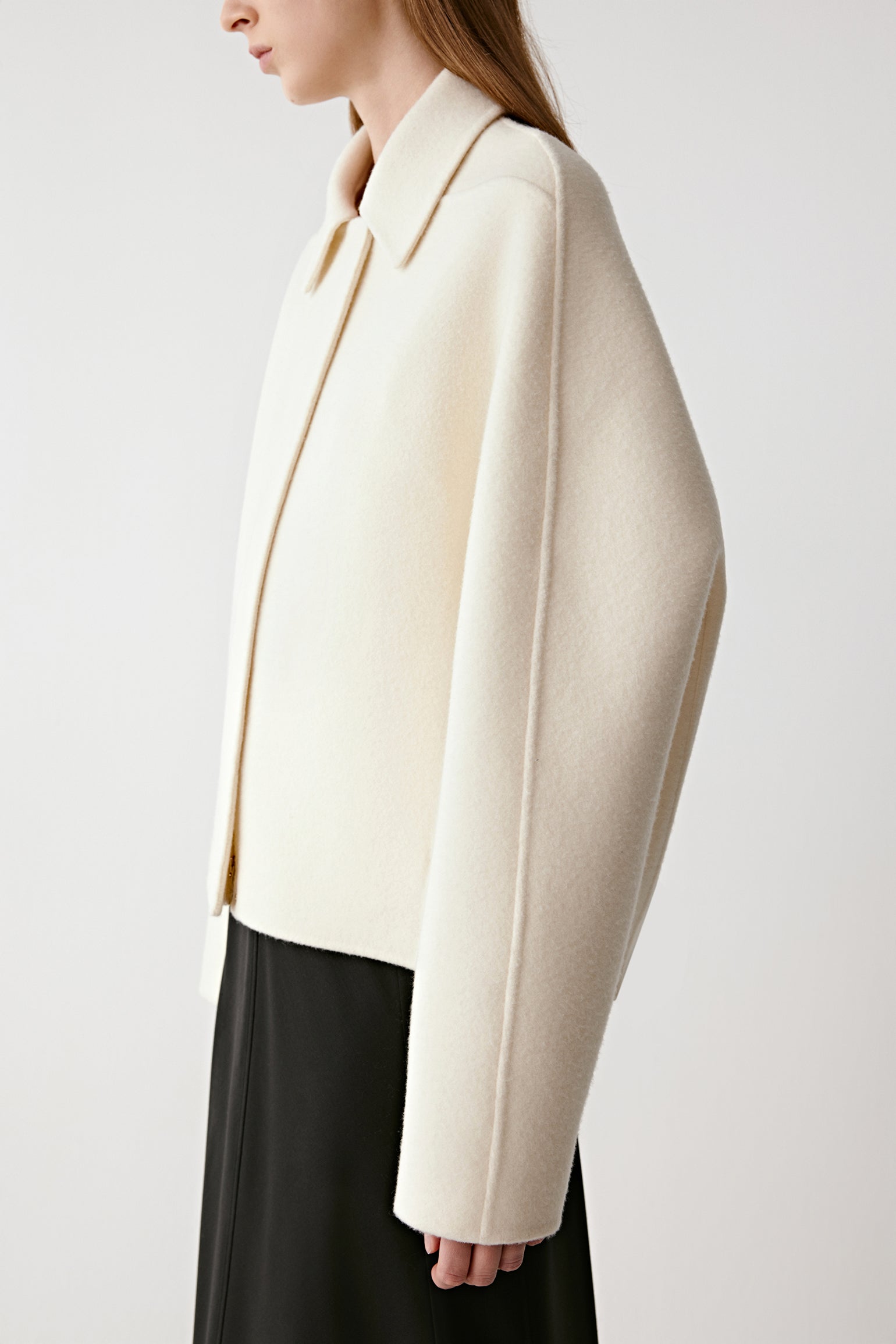 Side angle showing the natural drape and long hemline.