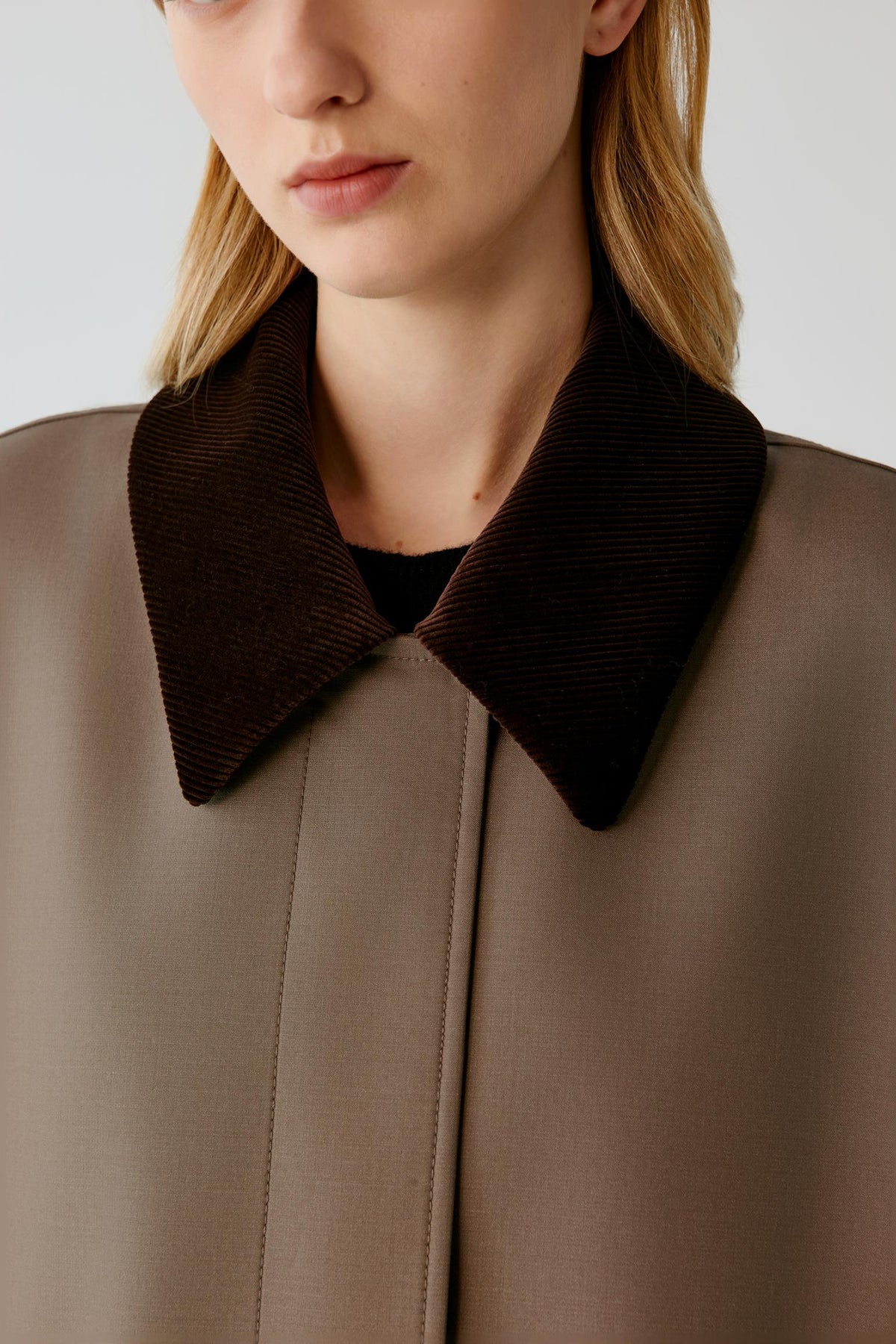 Close-up highlighting the dark brown corduroy collar and smooth dusty brown surface of the wool and silk coat.