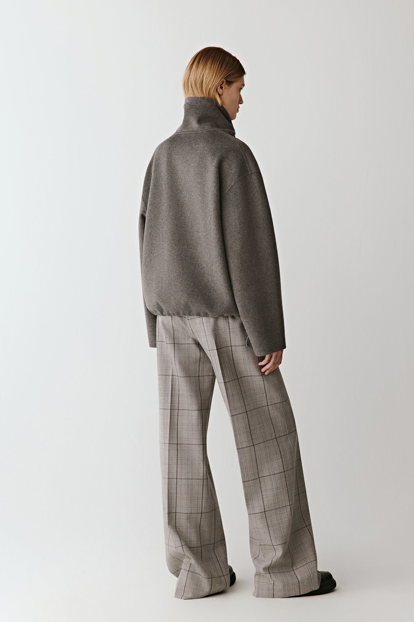 Back view showing the elegant drape and refined structure of the jacket.