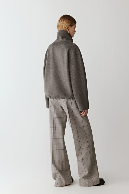 Back view showing the elegant drape and refined structure of the jacket.