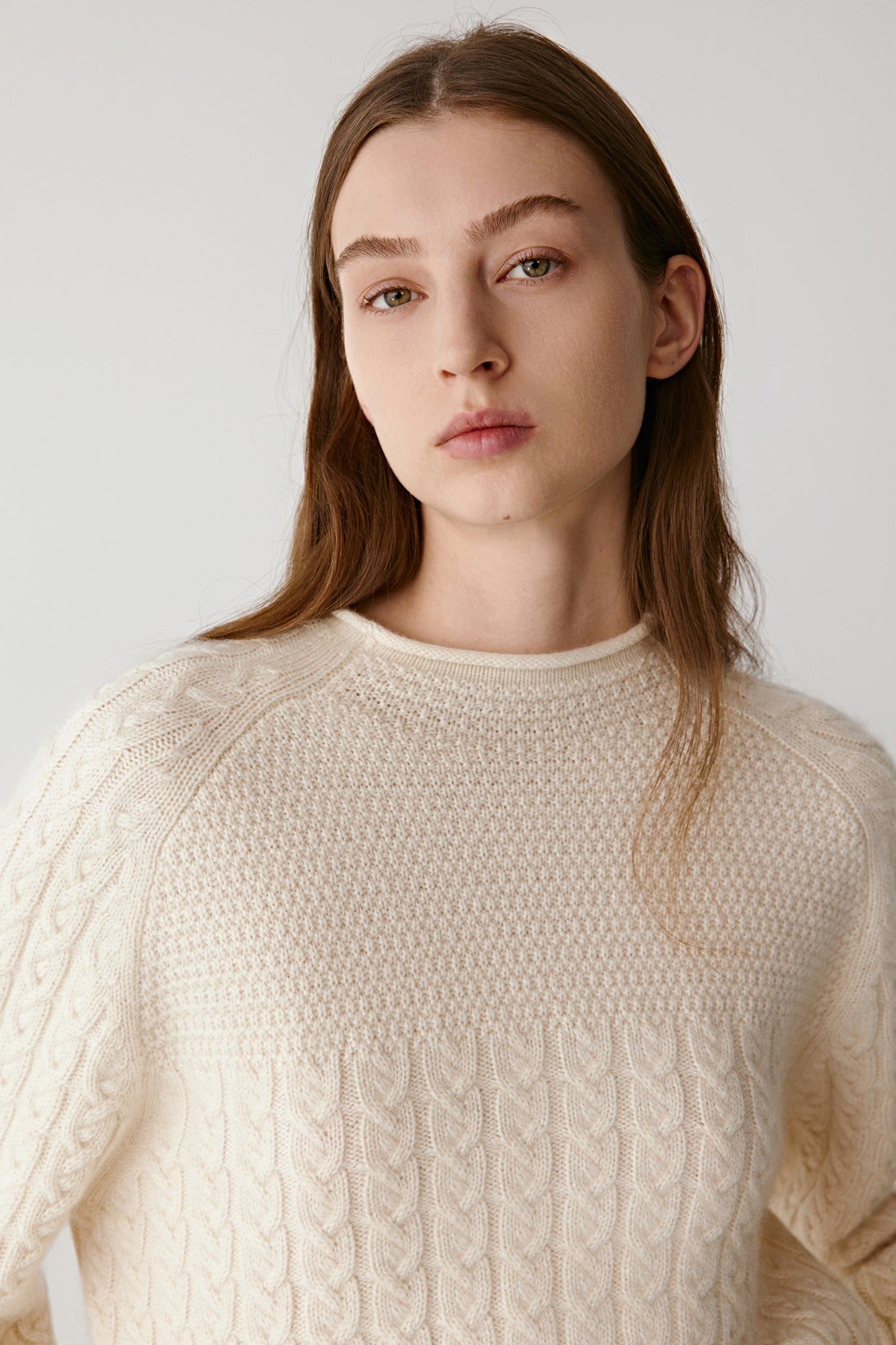 Three-quarter front view showing the textured knit pattern and ribbed cuffs.