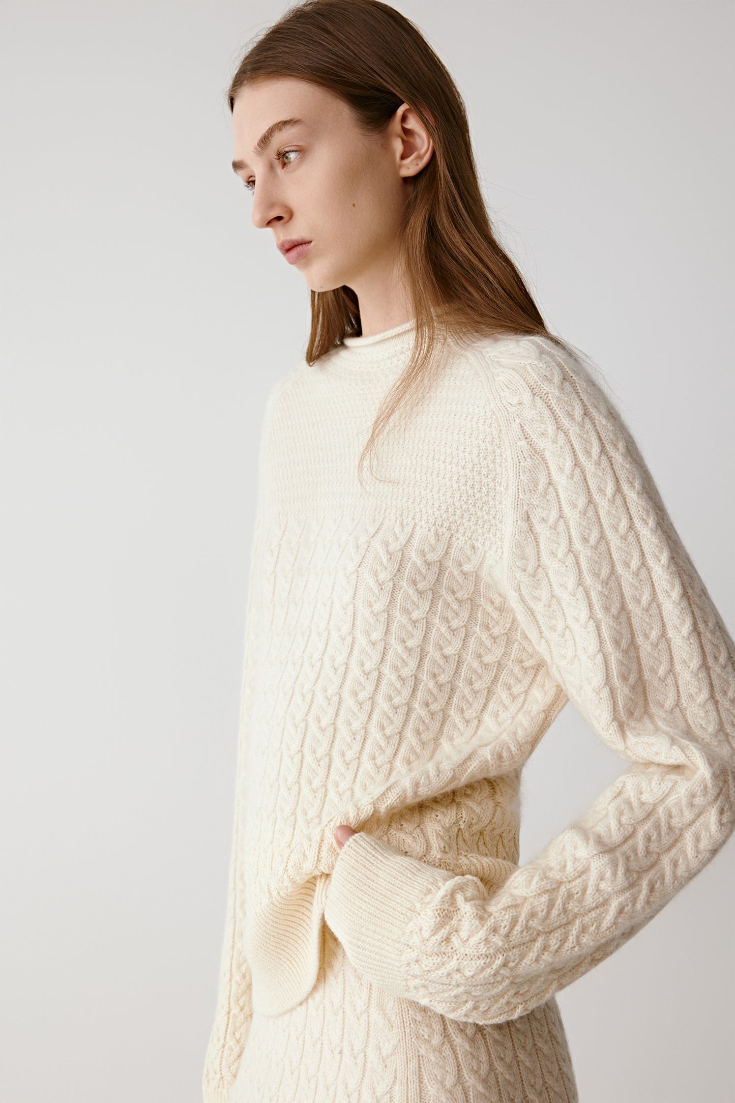 Profile view of the model highlighting the tactile cashmere knit.