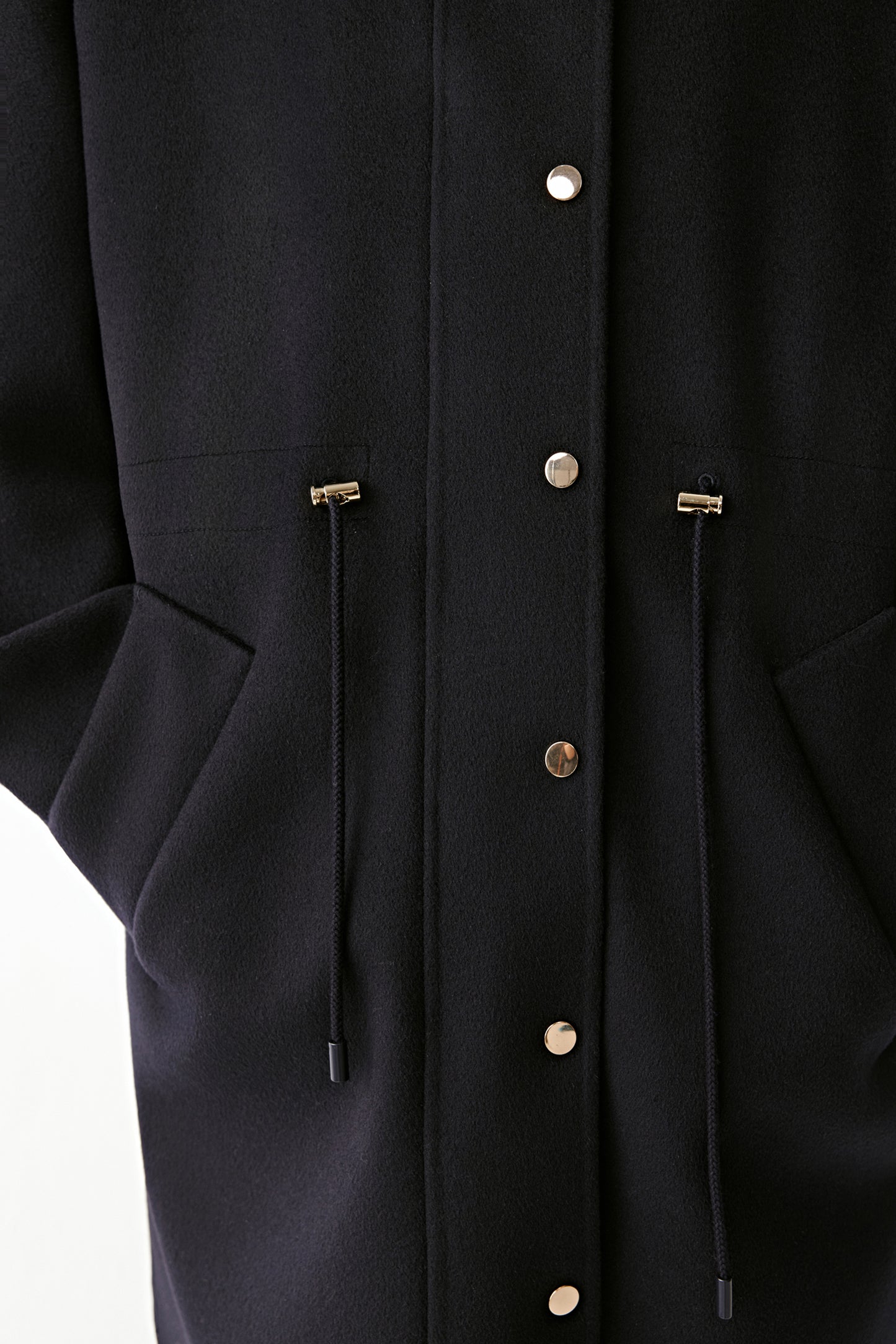 Portrait of the model highlighting the structured collar and soft texture of the wool and silk fabric.